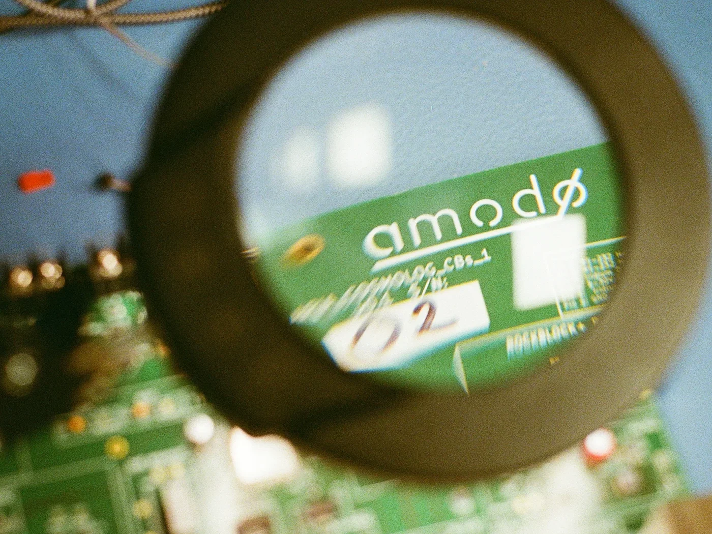 An Amodo prototype board, seen through a magnifying glass.