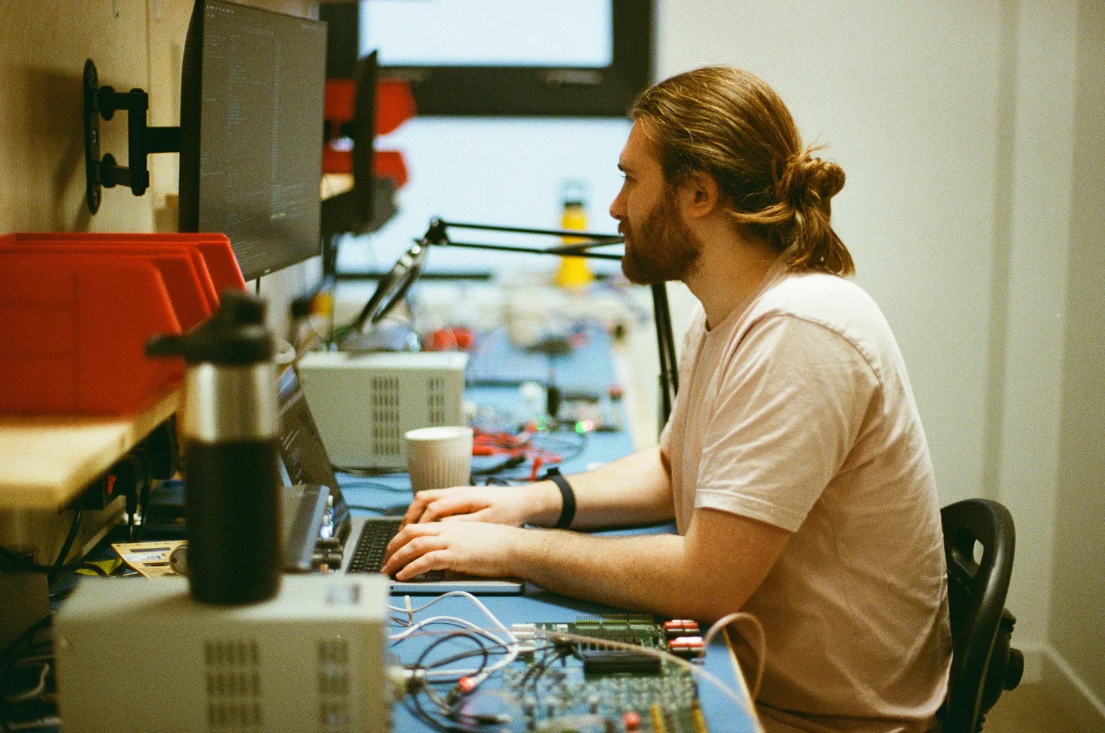 An engineer working at the electronics bench.